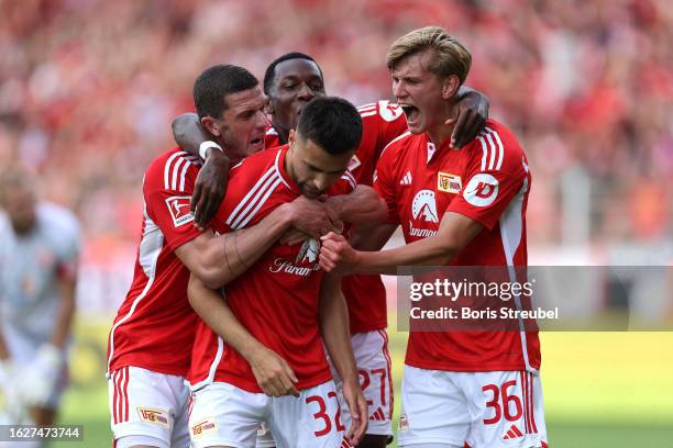 Milos Pantovic of 1. FC Union Berlin celebrates with Sheraldo Becker, Robin Gosens and Aljoscha Kemlein of 1. FC Union Berlin after scoring the...