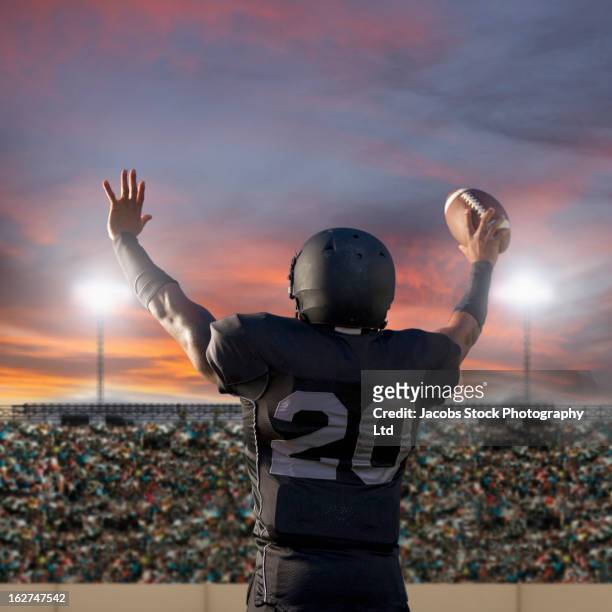 african american football player holding ball - phoenix arizona stock pictures, royalty-free photos & images