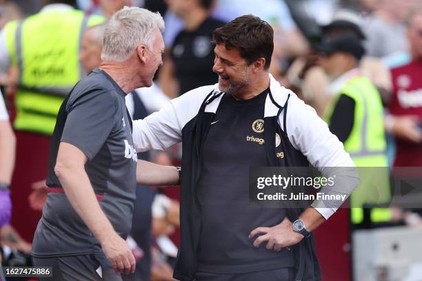 David Moyes, Manager of West Ham United, and Mauricio Pochettino, Manager of Chelsea, interact prior to the Premier League match between West Ham...