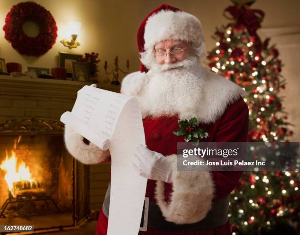 santa reading list - reading glasses stock pictures, royalty-free photos & images