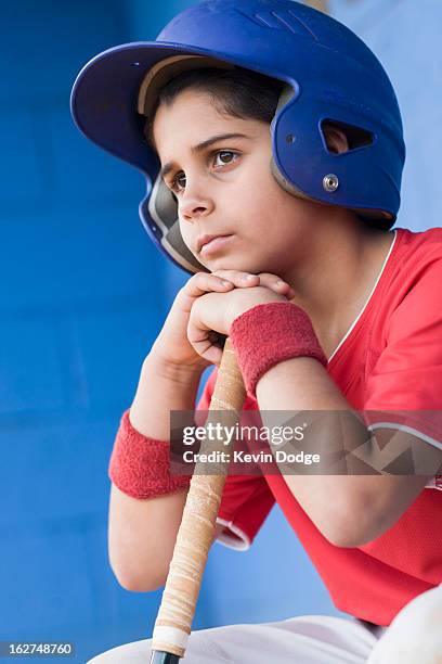 sad hispanic baseball player - sports dugout fotografías e imágenes de stock