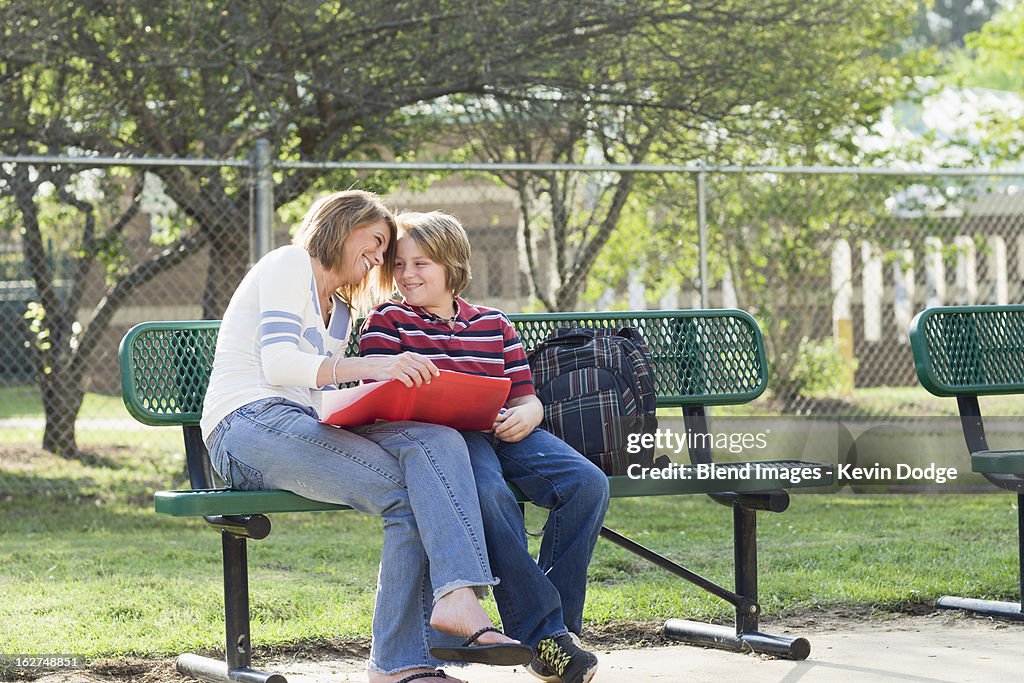 Caucasian mother and son looking at homework