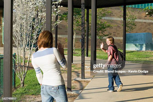 caucasian mother waving to son - farewell in 2012 stock pictures, royalty-free photos & images