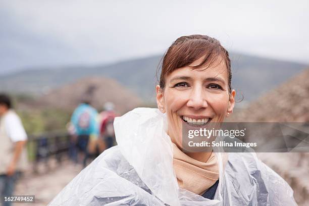 smiling hispanic woman in rain coat - mexico city tourist stock pictures, royalty-free photos & images