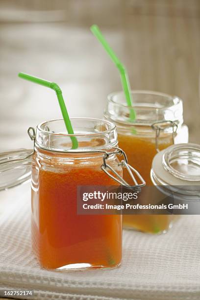 carrot and orange juice in preserving jars with straws - bendy straw stock pictures, royalty-free photos & images