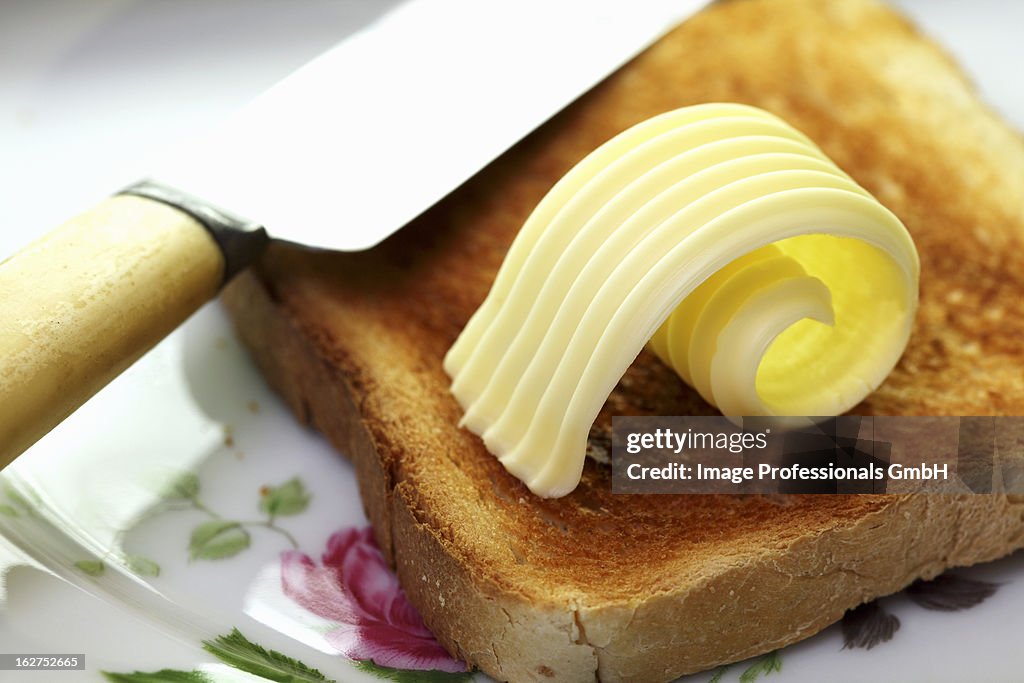 Slice of toast with curl of butter