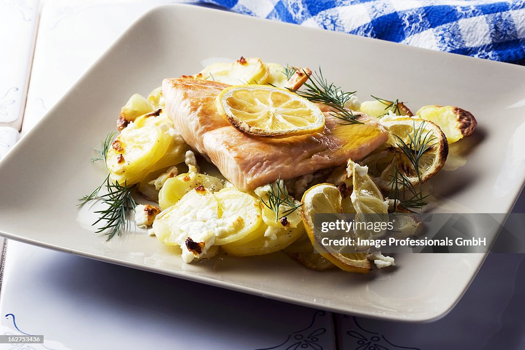 Salmon fillet with potatoes, lemons and feta cheese