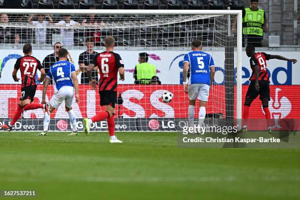 Randal Kolo Muani of Eintracht Frankfurt scores the team's first goal from the penalty spot during the Bundesliga match between Eintracht Frankfurt...