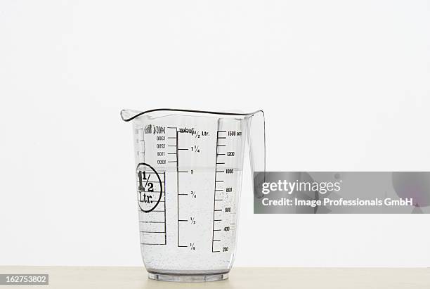 measuring jug on white background - measuring jug stock pictures, royalty-free photos & images