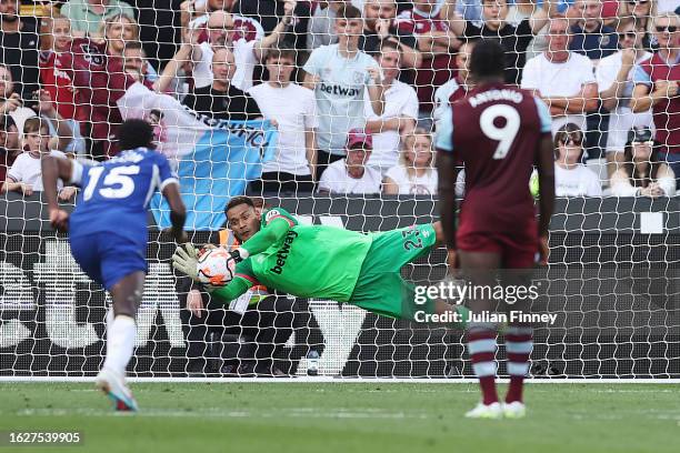 Alphonse Areola of West Ham United saves a penalty from Enzo Fernandez of Chelsea during the Premier League match between West Ham United and Chelsea...