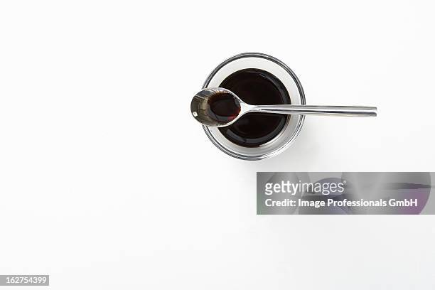 balsamic vinegar in glass bowl with spoon - balsamic vinegar stock pictures, royalty-free photos & images
