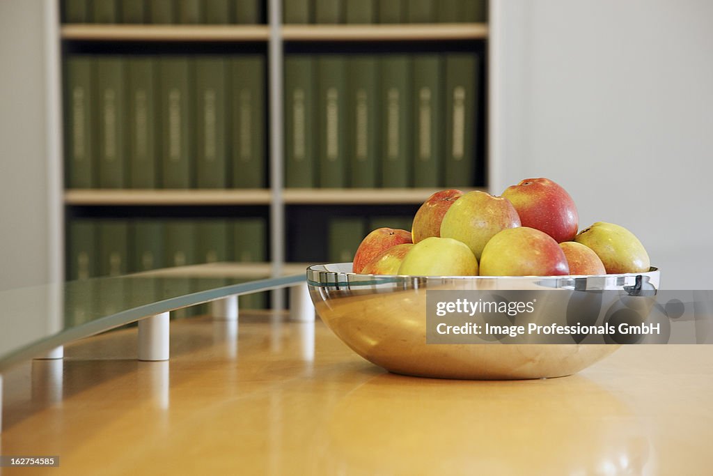 Fresh apples in silver bowl on table