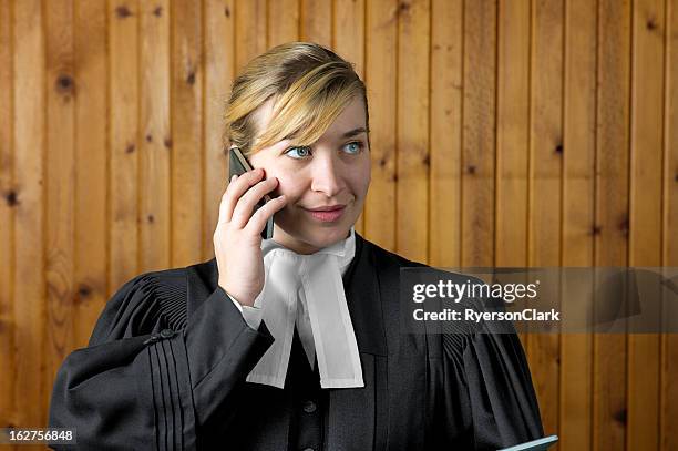 barrister or lawyer in traditional robes on her mobile phone - robe stockfoto's en -beelden