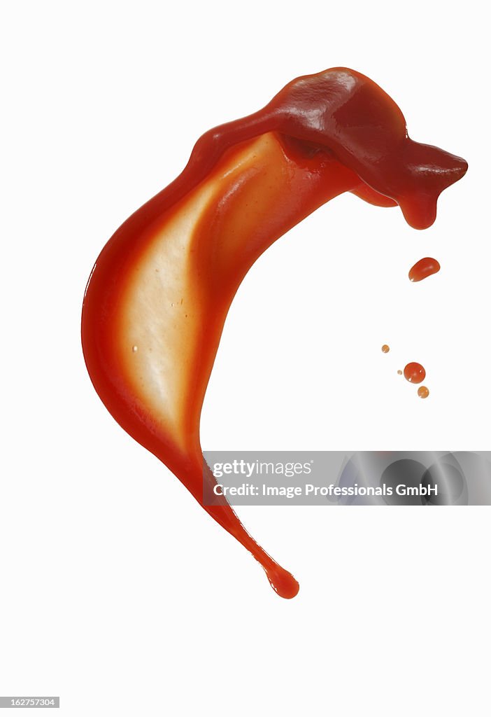 Squirted tomato sauce against white background