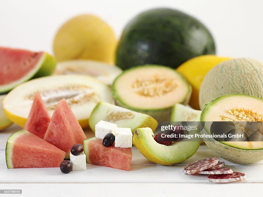 Various types of melon with feta and salami