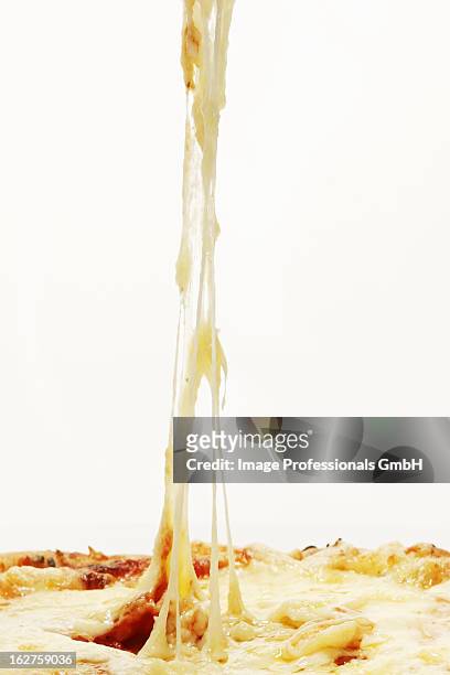 strings of cheese coming off pizza - cheese pull stockfoto's en -beelden