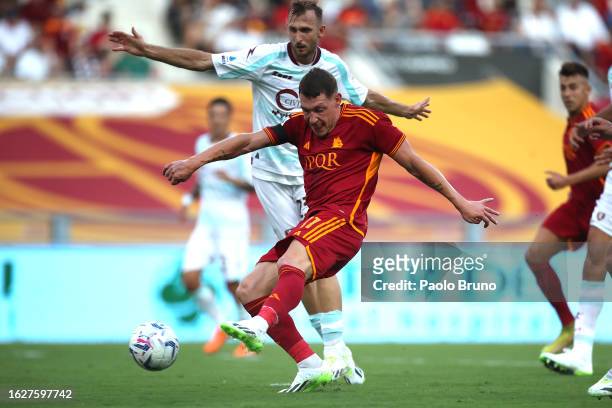 Andrea Belotti of AS Roma scores the team's first goal watched on by Norbert Gyomber of US Salernitana during the Serie A TIM match between AS Roma...