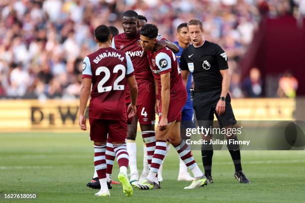 Nayef Aguerd of West Ham United is consoled by teammate Kurt Zouma following his sending off after being shown a second yellow card by referee John...