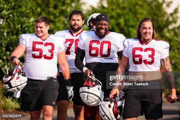 Ricky Stromberg, Sam Cosmi, Jaryd Jones-Smith, and Nick Gates of the Washington Commanders take the field during training camp at OrthoVirginia...