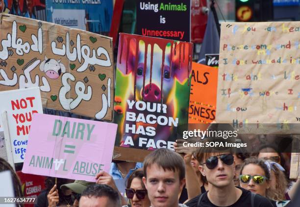 Protester holds a placard which states 'Your bacon has a face' during the demonstration. Crowds marched through central London during the National...