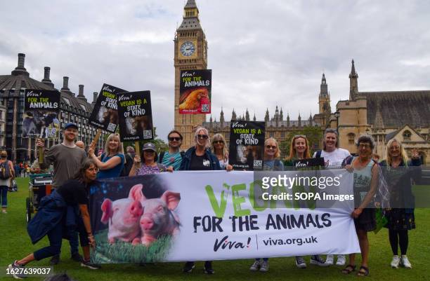 Protesters hold a vegan banner and placards during the demonstration in Parliament Square. Crowds marched through central London during the National...