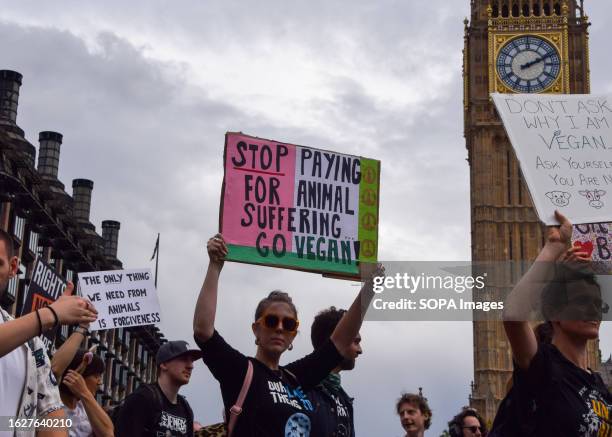 Protester holds a pro-vegan placard during the demonstration in Parliament Square. Crowds marched through central London during the National Animal...