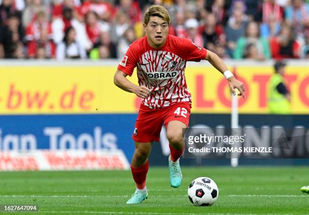 Freiburg's Japanese forward Ritsu Doan controls the ball during the German first division Bundesliga football match between SC Freiburg and Werder...