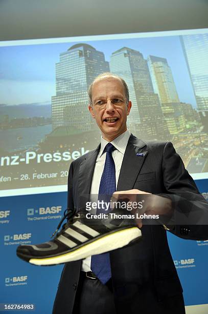 Kurt Bock, Chairman of the Board of Executive Directors at BASF SE, pauses with a brand new addidas running shoe with newly designed Basf technology...