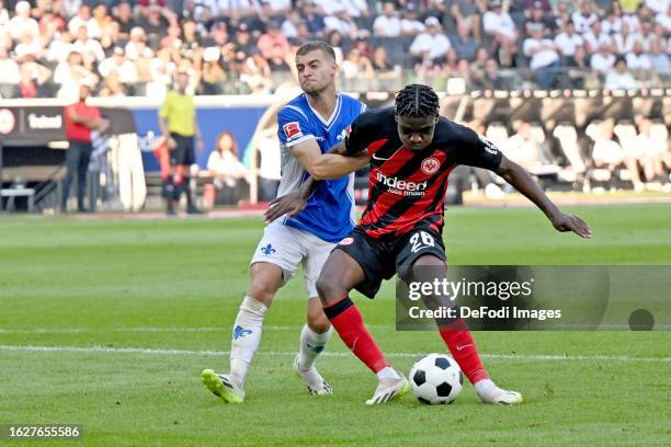 Fabian Nuernberger of SV Darmstadt 98 and Junior Dina Ebimbe of Eintracht Frankfurt battle for the ball during the Bundesliga match between Eintracht...