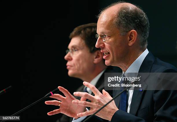 Hans-Ulrich Engel, chief financial officer of BASF SE, left, listens as Kurt Bock, chief executive officer of BASF SE, speaks during a news...