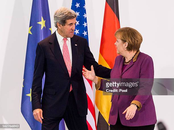 German Chancellor Angela Merkel receives U.S. Secretary of State John Kerry as they give a statement to the press on February 26, 2013 in Berlin,...