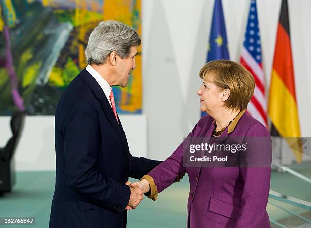 German Chancellor Angela Merkel receives U.S. Secretary of State John Kerry as they give a statement to the press on February 26, 2013 in Berlin,...