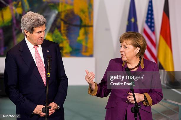 German Chancellor Angela Merkel receives U.S. Secretary of State John Kerry as they give a statement to the press on February 26, 2013 in Berlin,...