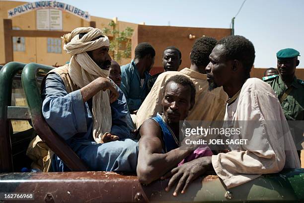 Some of nine prisoners, comprising seven Malian, one Nigerois and one Mauritanian, are taken out of a jail at the gendarmerie in the northern Malian...