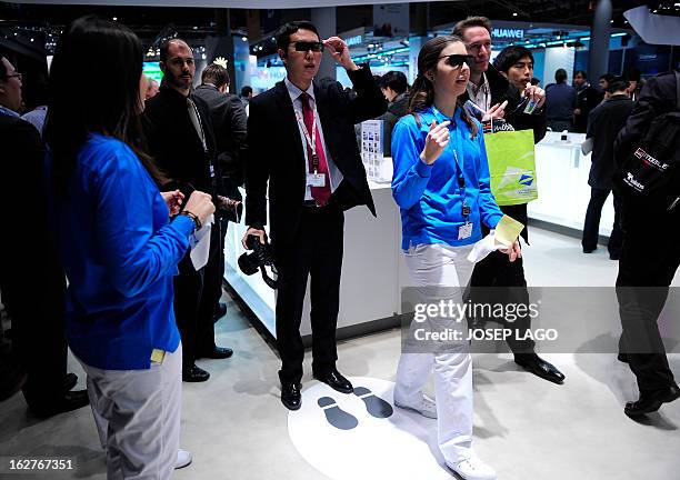 People test a new Samsung 3D device in Barcelona on February 26 on the second day of the 2013 Mobile World Congress. The 2013 Mobile World Congress,...