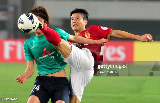 Sun Xiang of Guangzhou Evergrande and Genki Haraguchi of Urawa Red Diamonds battle for the ball during the AFC Champions League match between...