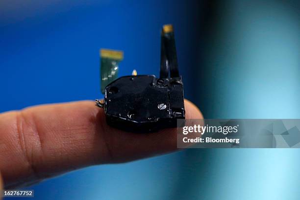 An STMicroelectronics NV Mobile Projector device is displayed for a photograph on an employee's finger at the Mobile World Congress in Barcelona,...