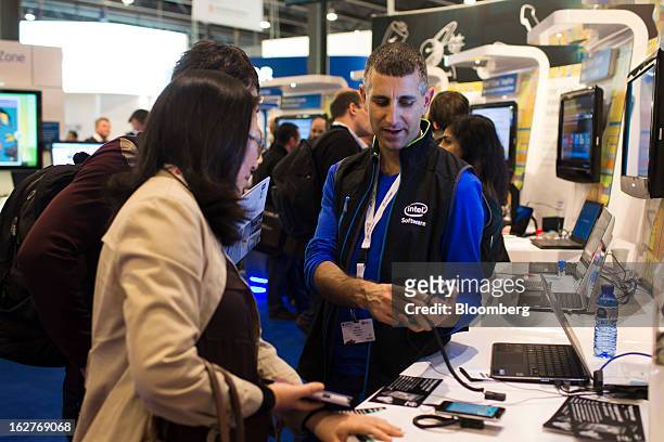 An employee demonstrates a map application on a mobile device at the Intel Corp. Pavilion at the Mobile World Congress in Barcelona, Spain, on...