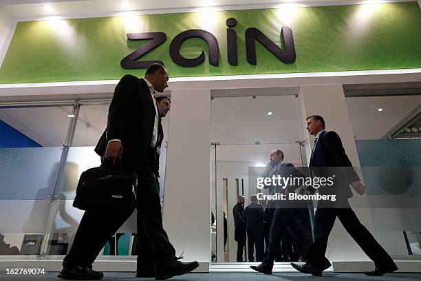 Visitors pass the Zain Group pavilion at the Mobile World Congress in Barcelona, Spain, on Tuesday, Feb. 26, 2013. The Mobile World Congress, where...