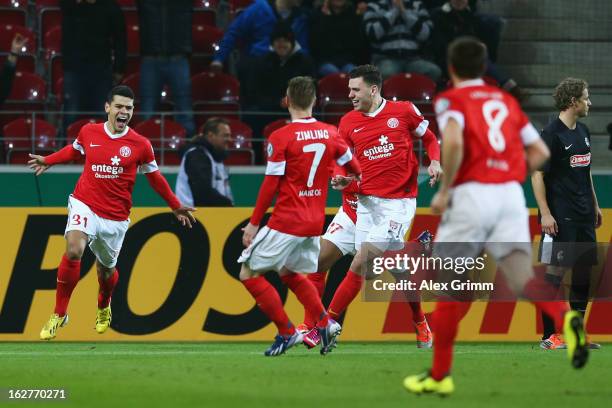 Shawn Parker of Mainz celebrates his team's first goal with team mates during the DFB Cup Quarter Final match between FSV Mainz 05 and SC Freiburg at...