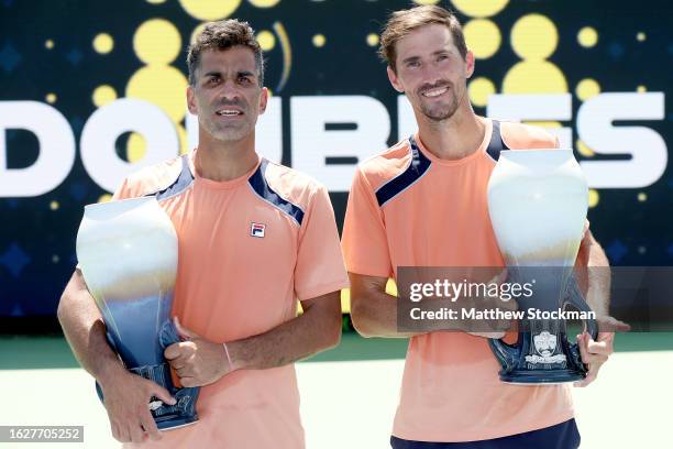 Maximo Gonzalez and Andres Molteni of Argentina pose with their trophies after defeating Jamie Murray of Great Britain and Michael Venus of New...