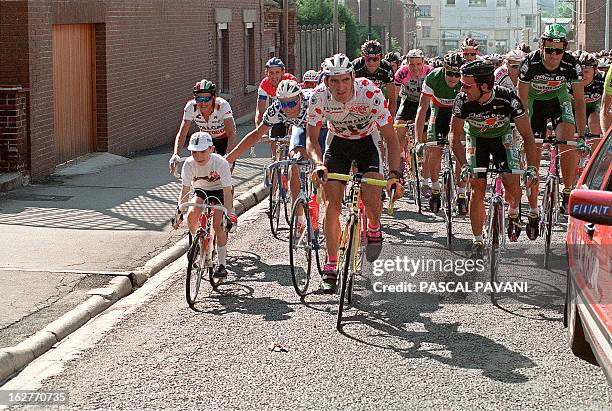 Little boy rides neck and neck the pack during the 06th lap of the 78th Tour of France from Arras to le Havres 11 July 1991. The Tour de France ,...