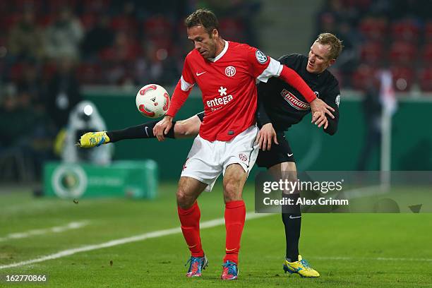 Nikolce Noveski of Mainz is challenged by Jan Rosenthal of Freiburg during the DFB Cup Quarter Final match between FSV Mainz 05 and SC Freiburg at...