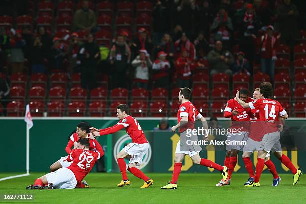 Shawn Parker of Mainz celebrates his team's first goal with team mates during the DFB Cup Quarter Final match between FSV Mainz 05 and SC Freiburg at...