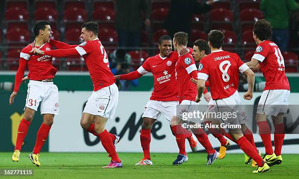 Shawn Parker of Mainz celebrates his team's first goal with team mates during the DFB Cup Quarter Final match between FSV Mainz 05 and SC Freiburg at...