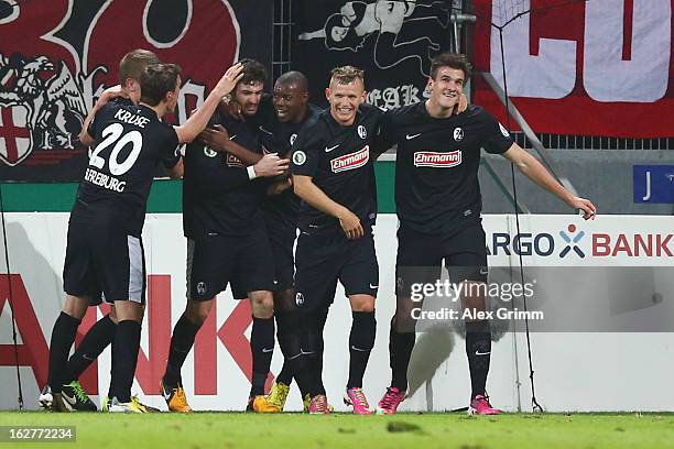 Daniel Caligiuri of Freiburg celebrates his team's second goal with team mates during the DFB Cup Quarter Final match between FSV Mainz 05 and SC...