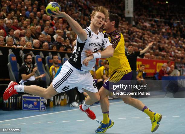 Aron Palmarsson of Kiel is challenged by Ivan Nincevic of Berlin during the DKB Handball Bundesliga match between THW Kiel and Fuechse Berlin at...