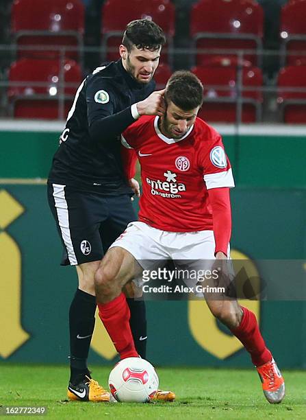 Marco Caligiuri of Mainz is challenged by Daniel Caligiuri of Freiburg during the DFB Cup Quarter Final match between FSV Mainz 05 and SC Freiburg at...