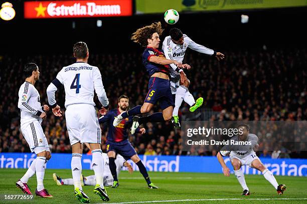 Carles Puyol of FC Barcelona jumps for the ball with Ricardo Varene of Real Madrid CF during the Copa del Rey Semi Final second leg between FC...