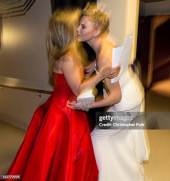 Jennifer Aniston and Charlize Theron backstage during the Oscars held at the Dolby Theatre on February 24, 2013 in Hollywood, California.